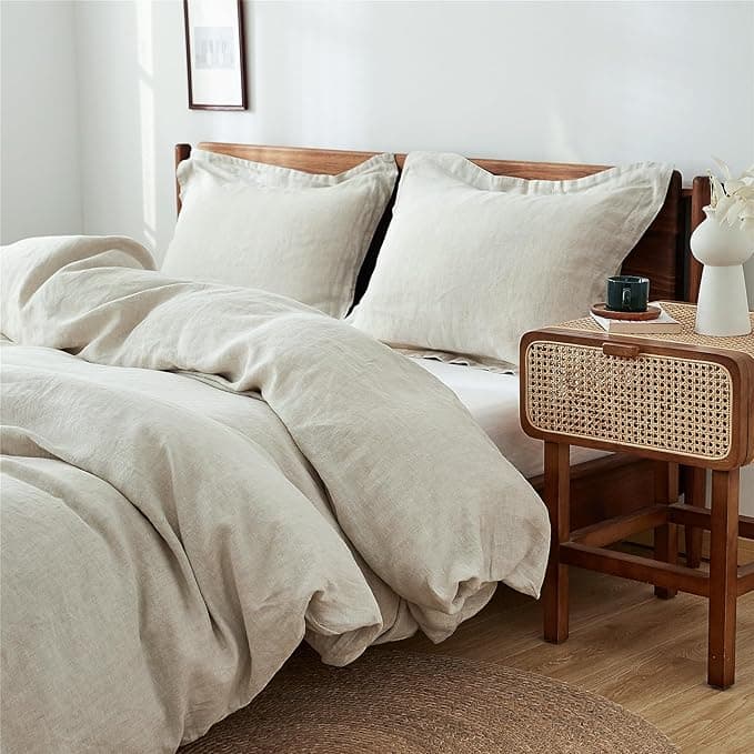 Stonewashed French linen duvet cover set in warm oat color on a neatly made bed
